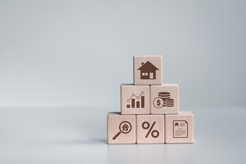 Real estate investment icons on wooden block for analyzing mortgage loan home and insurance real...