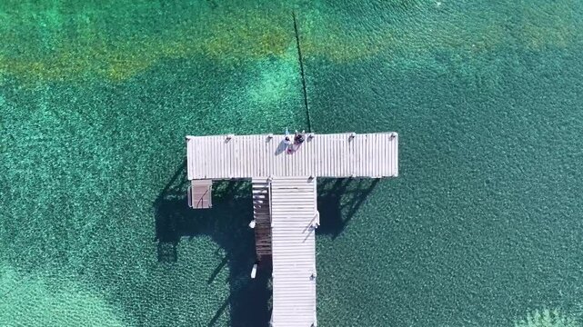 People On The Pier At Villa La Angostura In Neuquen Argentina. Snowy Mountains. Angostura Village. Father And Son On The Pier. People On The Pier At Villa La Angostura In Neuquen Argentina.