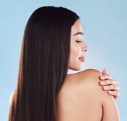Naklejka premium Beauty, hair and back of woman in studio for salon, wellness and keratin treatment for texture. Hairdresser, spa aesthetic and isolated person with shine, cosmetics and health on blue background
