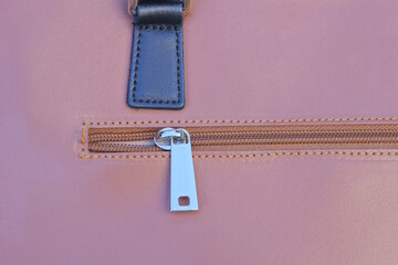 one closed white metal zip on brown leather bag © butus