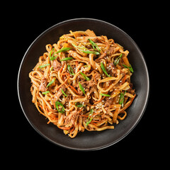 Delicious beef stir-fried noodles garnished with green onions and sesame, served in a black bowl on a dark background