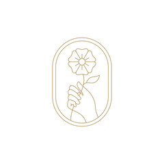Elegant woman hand with natural flower in ellipse golden frame line art icon vector illustration. Gentle feminine arm with wildflower floral blossom luxury logo for organic cosmetic spa relax salon