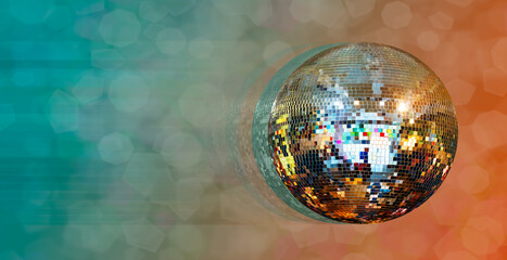 Party disco mirror ball reflecting orange and green lights
