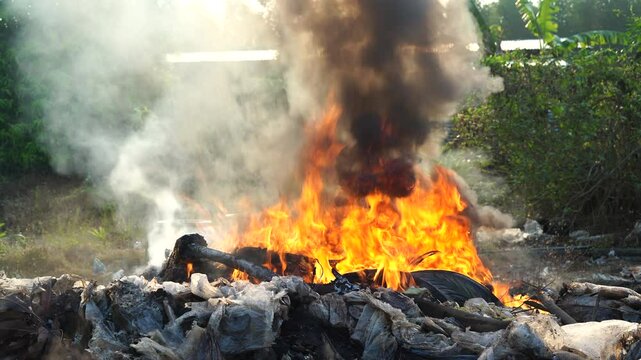 Fire is burning in a pile of garbage.