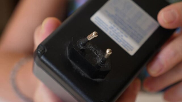 Close-up of a broken charger, in need of repair or replacement. The damaged device shows signs of wear and tear, highlighting its unusability