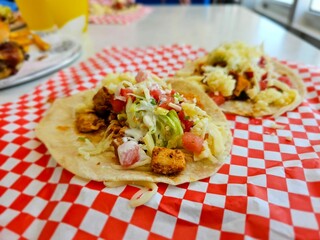 Close-up of tacos with chicken and vegetables.