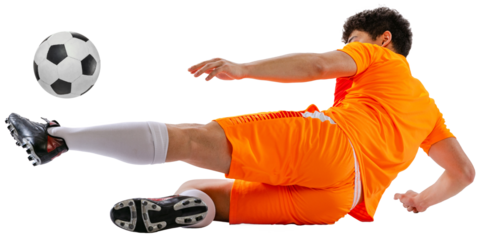 Dynamic image of determined athlete, soccer player in orange football kit training falling down while kicking ball isolated on white transparent background. Concept of sport, competition, game