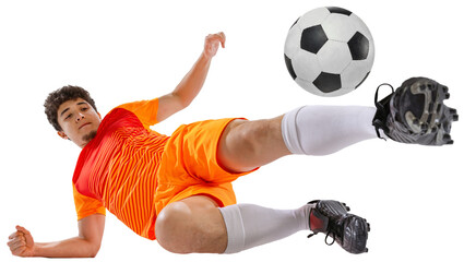 Dynamic image of determined athlete, soccer player in orange football kit training falling down while kicking ball isolated on white transparent background. Concept of sport, competition, game