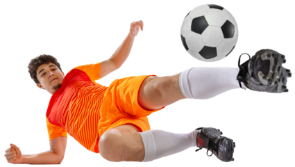 Dynamic image of determined athlete, soccer player in orange football kit training falling down while kicking ball isolated on white transparent background. Concept of sport, competition, game