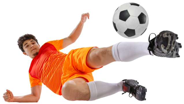 Dynamic image of determined athlete, soccer player in orange football kit training falling down while kicking ball isolated on white transparent background. Concept of sport, competition, game