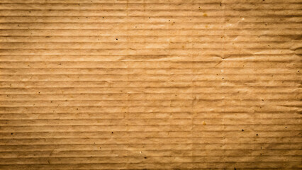 Fototapeta premium Parallel ridges and dark spots on brown corrugated cardboard, a versatile texture for various applications. Rough, brown corrugated cardboard surface, ideal for adding depth and texture to designs.
