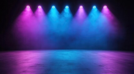 Vibrant stage lights in blue and pink hues illuminating a misty floor, perfect for concerts or theatrical performances.