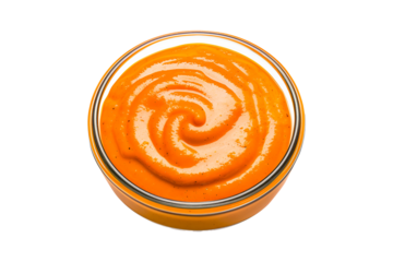 Closeup of smooth Peri-Peri sauce in glass bowl isolated on a white transparent background. Concept of food or culinary ingredient