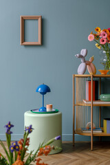 Playful living room scene with vibrant flowers, bold candle holders, and a sculptural balloon dog....