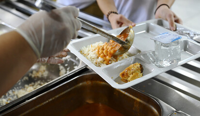 employee receiving food from the workplace cafeteria
