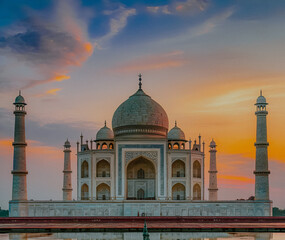 The Taj Mahal, a stunning mausoleum made of ivory-white marble, stands majestically on the right bank of the Yamuna River in Agra, Uttar Pradesh, India.