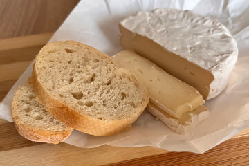sliced camembert cheese and slices of white bread close up