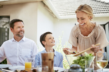 Food, family and green salad with vegetables, family and party with summer event, nutrition and ingredients. Parents, recipe and son with lunch, eating and organic with cuisine, child and gourmet