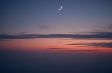 A serene evening sky with a crescent moon and plenty of room to copy the image. Night landscape.