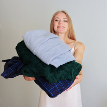 girl clearing her wardrobe of unnecessary clothes. second life for things