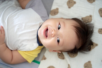 a baby laying on top of a bed