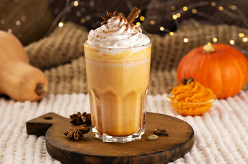 Pumpkin spice latte with whipped cream and ingredients.