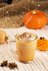 Pumpkin spice latte with whipped cream and ingredients.
