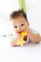 a baby is holding a banana in his mouth