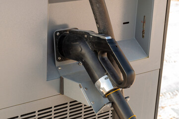 Close-up of an electric vehicle refueling gun