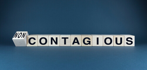 A conceptual image featuring wooden blocks spelling CONTAGIOUS and NON-CONTAGIOUS