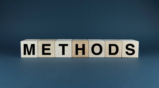 A close-up of wooden blocks spelling out METHODS