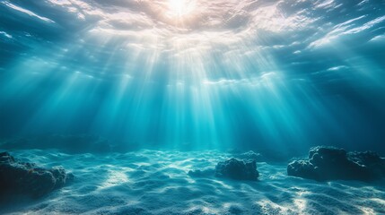 Underwater view of the ocean floor with sunlight filtering through the water