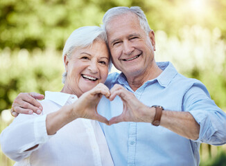 Portrait, heart hands and happy senior couple outdoor for support, care or love emoji. Face, man and woman with sign for romance, loyalty and connection for relationship on valentines day in nature