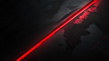 Naklejka premium A red line is shown on a black background. The red line is long and thin, and it is glowing. The image has a futuristic and mysterious feel to it