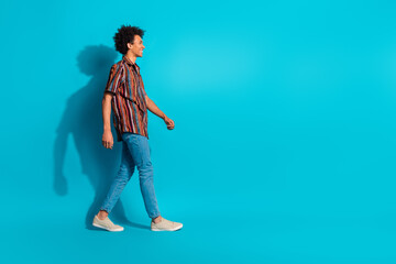 Naklejka premium Full size profile photo of nice young man walk empty space wear shirt isolated on teal color background