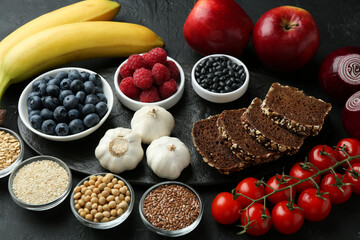 Different fresh products on black table. Source of prebiotics