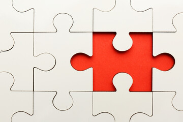 White puzzle with missing piece on red background, top view