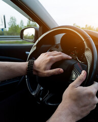  hands holding steering wheel