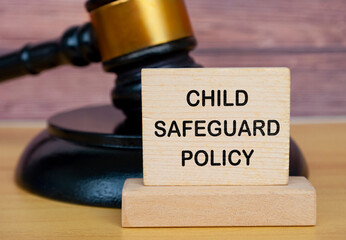 Child Safeguard Policy text on wooden blocks with gavel background. Safeguarding child policy...