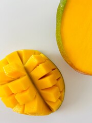 Ripe Mango Fruit Cut into Cubes Isolated on White Background