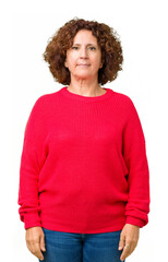 Beautiful middle ager senior woman red winter sweater over isolated background Relaxed with serious expression on face. Simple and natural looking at the camera.