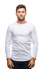 Fototapeta premium Young handsome man over isolated background with serious expression on face. Simple and natural looking at the camera.