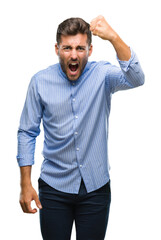 Young handsome man over isolated background angry and mad raising fist frustrated and furious while shouting with anger. Rage and aggressive concept.