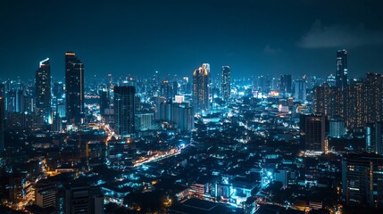 Night cityscape with skyscrapers and street lights.