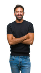 Adult hispanic man over isolated background happy face smiling with crossed arms looking at the...