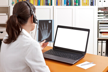Telemedicine concept: doctor or pharmacist with headset during a video call with another doctor...