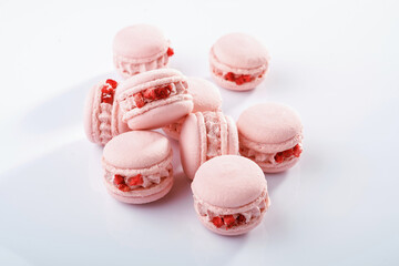 Pink colored. Bunch of macarons on the white surface