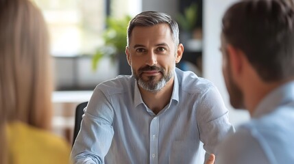 Middle-aged Professional Receiving Constructive Feedback in Modern Office Environment