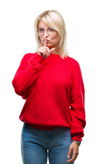 Young beautiful blonde woman wearing sweater and glasses over isolated background asking to be quiet with finger on lips. Silence and secret concept.