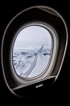 Swiss Alps seen through the window of  a private jet aircraft